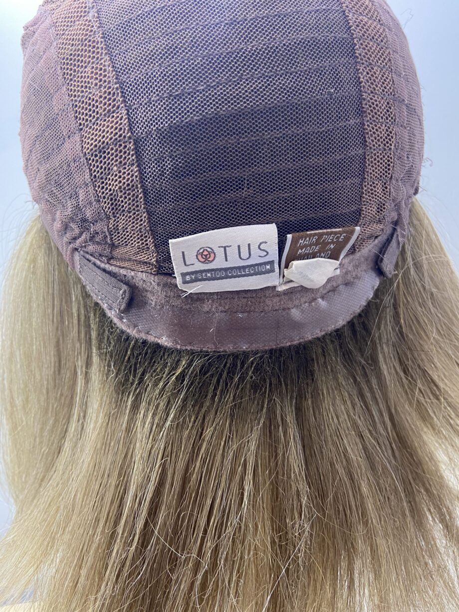 Rooted soft cap blonde wig.