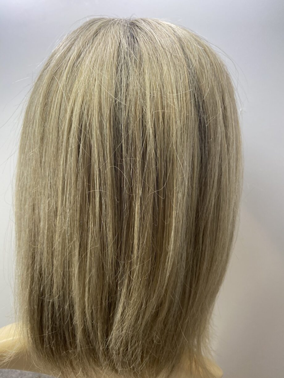 Rooted soft cap blonde wig.