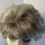 New tag on curly ash grey wig. Abmc95